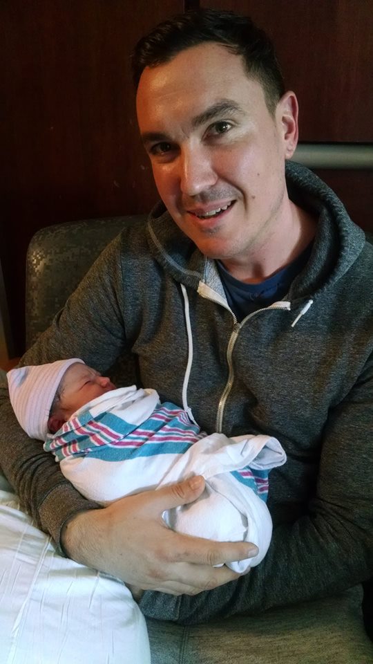 Christophe Hascoat, client of Tribe of Mine, holding his newborn child