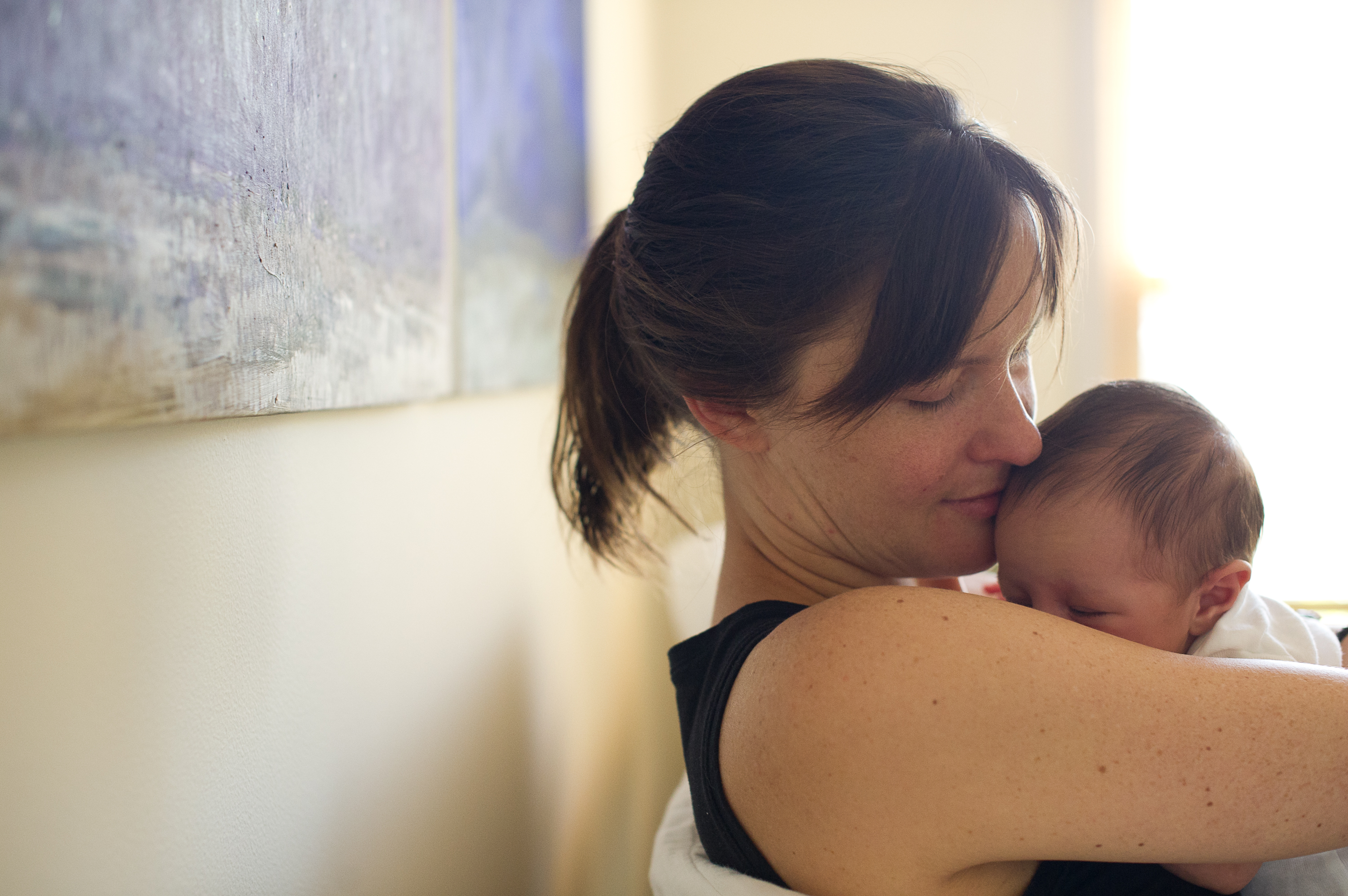 Kara McManus, Tribe of Mine client, holding her baby